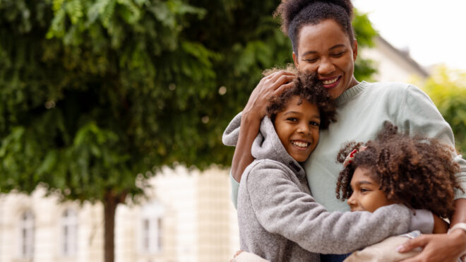 Black Family Single Mother, Son and Daughter Hugging and Smile in the City. Loving Mom, Boy and Girl Together Feels Fun. Carefree Weekend Concept